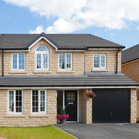 A stone house with windowsills and lintels painted in Stonelux Windowsill Paint in Magna 02.