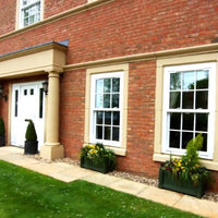 House with portico and window surrounds painted in Stonelux the stone range in the colour rich buff 17