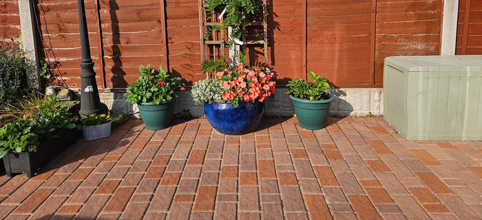Revitalised garden patio area after using Stonelux® Block Paving Stain, with rich, refreshed colour across block paving.