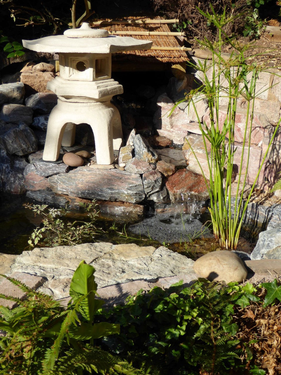 Rockingham 58 stone effect paint applied to a garden water feature ornament with a light warm limestone finish and gentle cream-beige warmth