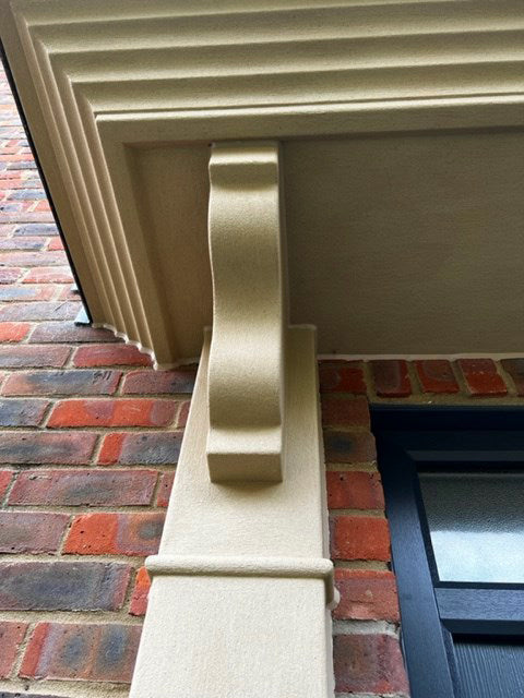 Close up of Buff 04 stone effect paint applied to an exterior door surround with a warm creamy beige Yorkstone finish