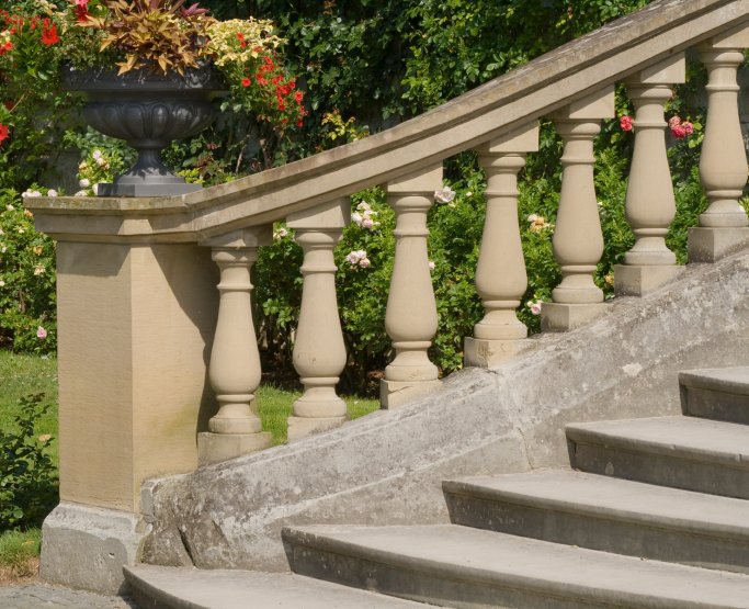 A balustrade painted with Stonelux Garden Paint in Rich Buff Sandstone, giving it a stone effect finish.
