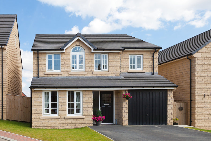 A stone house with windowsills and lintels painted in Stonelux Windowsill Paint in Magna 02.