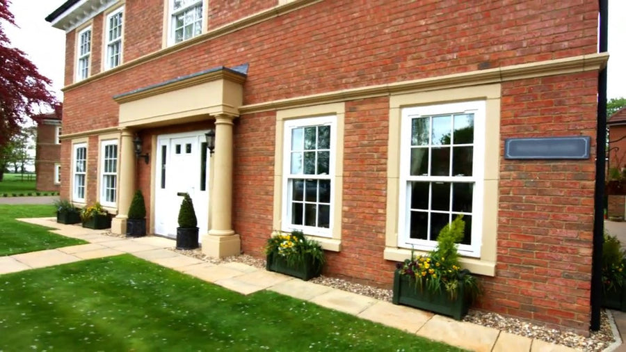 House with portico and window surrounds painted in Stonelux the stone range in the colour rich buff 17